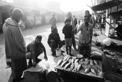 Group of people at market stall in city