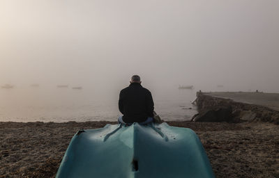 Adult man with fishing boat on port during sunrise. almeria, spain