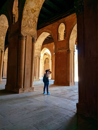 Man walking into a maze of architectures inside historical place