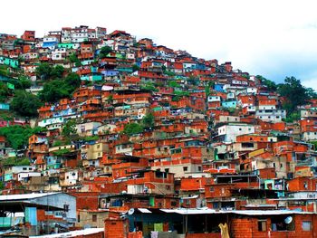 Houses on hill against sky