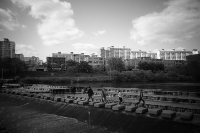 View of city buildings against cloudy sky