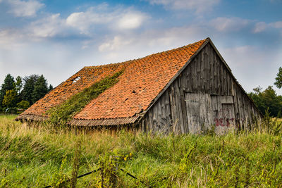 Low angle view of house against cloudy sky