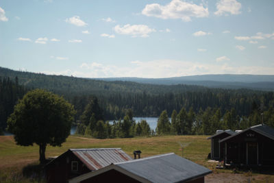 Houses on landscape against sky