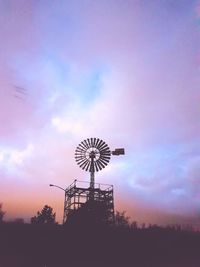 Low angle view of silhouette traditional windmill against sky during sunset