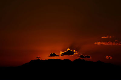 Silhouette birds against sky during sunset