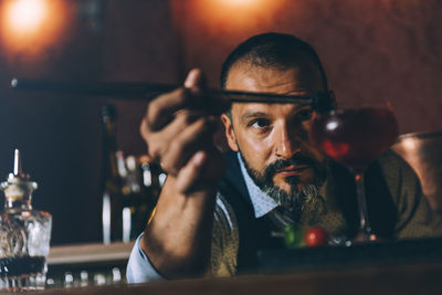 Portrait of a young man drinking glass