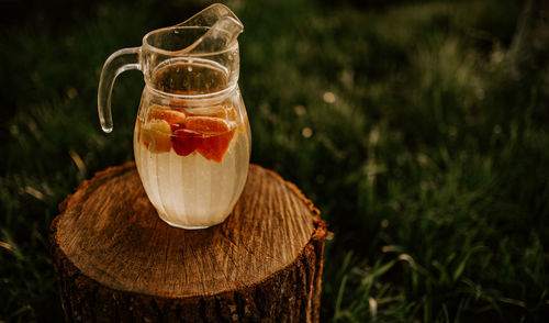 Close-up of drink in glass on field