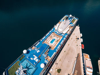 High angle view of ship moored on sea against buildings in city
