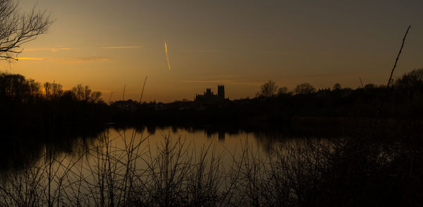 Scenic view of lake against sky during sunset