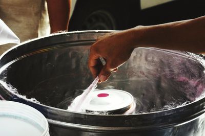 Close-up of hand making cotton candy