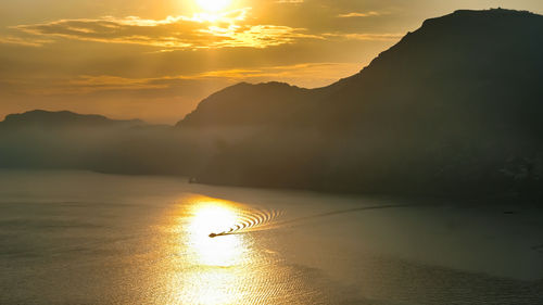 Scenic view of silhouette mountains against sky during sunset