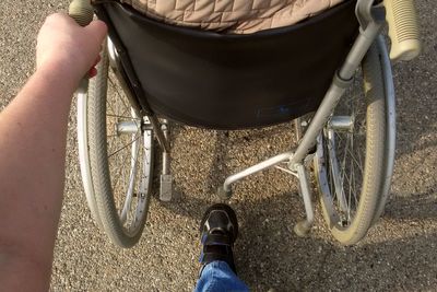 Low section of woman standing on road