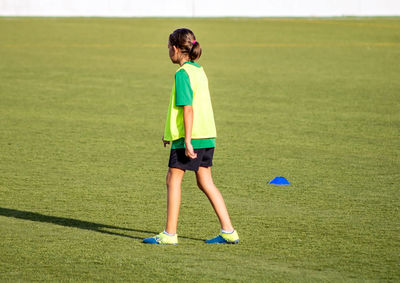 Full length of girl standing on field