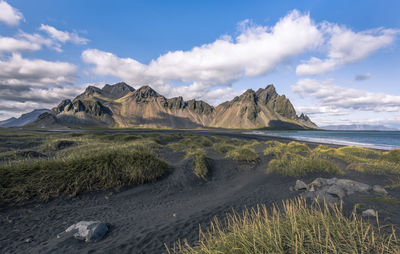 Scenic view of sea and mountains against sky