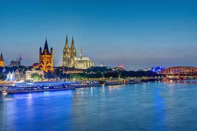 The famous skyline of cologne with the river rhine at dusk