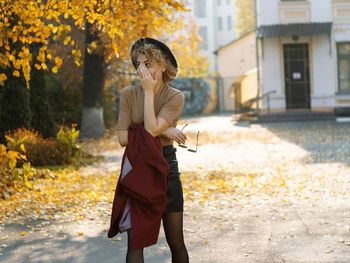 Side view of young woman walking on street