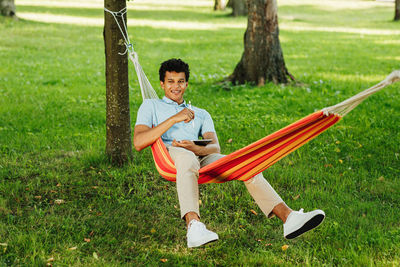 Portrait of smiling man sitting on grass