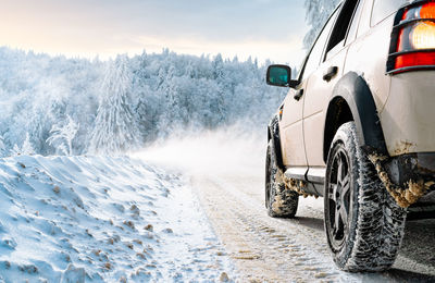 Low angle view of car on snowy mountain road during winter blizzard