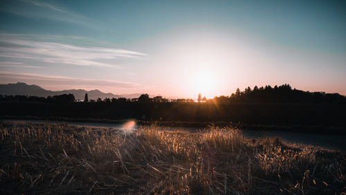 Scenic view of field against sky during sunset