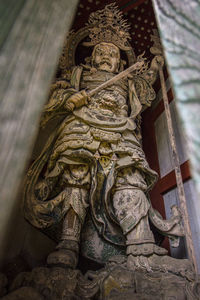 Low angle view of angel statue against historic building