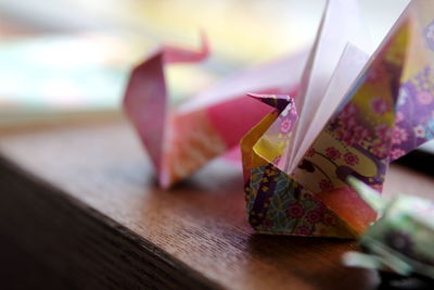 Close-up of paper birds on table