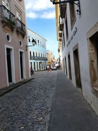 Surface level of footpath amidst buildings in city