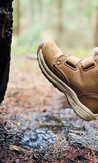 Low section of person wearing shoes on field