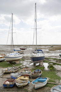 Fisherman boats stuck on the beach in low tide period in leigh-on-sea, uk.