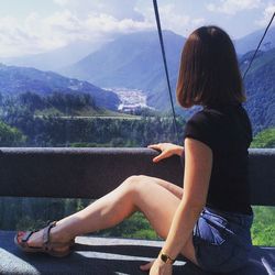 Side view of woman standing on mountain