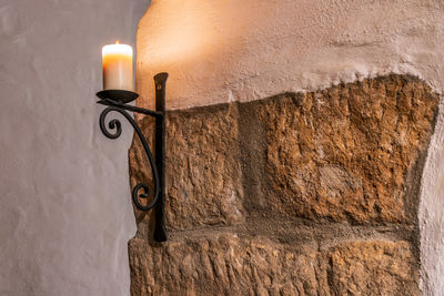 An old candlestick on the wall