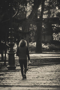 Rear view of woman walking in forest