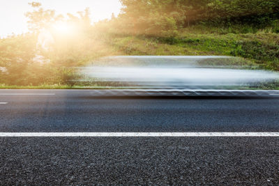 Blurred motion of road amidst trees