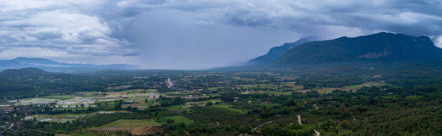 Scenic view of landscape against storm clouds