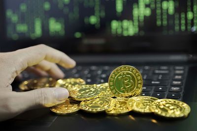 Close-up of hand holding coins