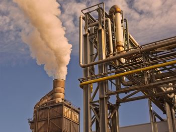 Low angle view of smoke stack against sky