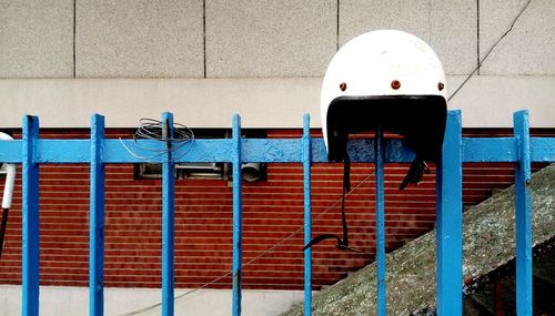 Helmet on blue fence