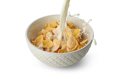 Close-up of fresh breakfast in bowl against white background