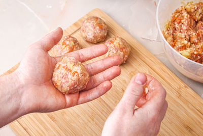 Cropped hand of person holding food