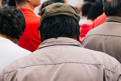 Rear view of man walking in crowd