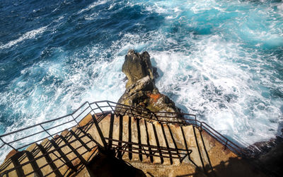 High angle view of rock by sea