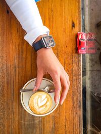 Midsection of person holding coffee cup