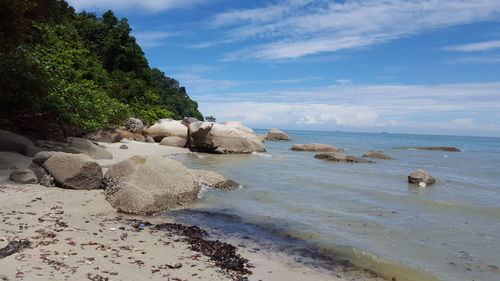 Rocks on beach against sky