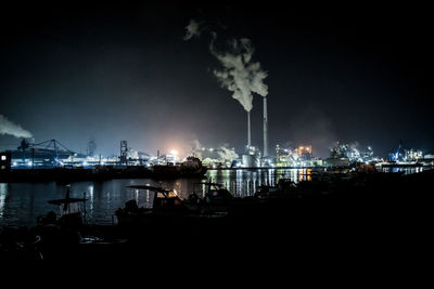 Smoke emitting from factory against sky at night