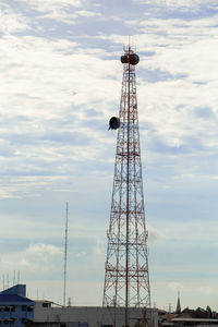 Low angle view of communications tower against sky