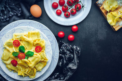 Italian pasta with ingredients and black background. gastronomic concept