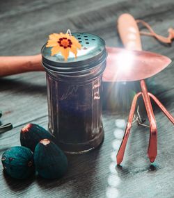 Close-up of hand holding drink on table