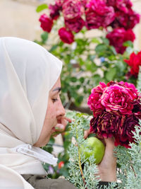 Low section of people holding bouquet of flowering plant