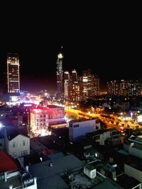 Illuminated cityscape against sky at night