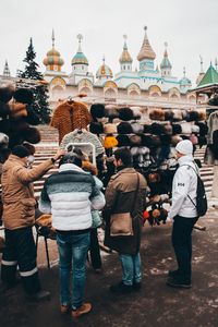 Rear view of people in temple outside building