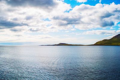 Scenic view of sea against cloudy sky